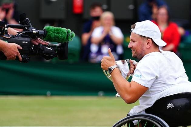 Mandatory Credit: Photo by Javier Garcia Shutterstock (12203621bg) Dylan Alcott celebrates with the trophy after victory in the Quad Wheelchair Singles final Wimbledon Tennis Championships, Day 12, The All England Lawn Tennis and Croquet Club, London, UK - 10 Jul 2021 Wimbledon Tennis Championships, Day 12, The All England Lawn Tennis and Croquet Club, London, UK - 10 Jul 2021  Copyright: xJavierxGarcia Shutterstockx 12203621bg