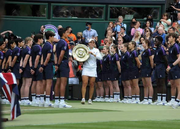 Lawn Tennis - 2021 All England Championships - Woman™s Final - Wimbledon Ashleigh Barty v Karolina Pliskova Ashleigh Barty of Australia shows off her Winners Shield in front of all the Ball Boys and Girls 