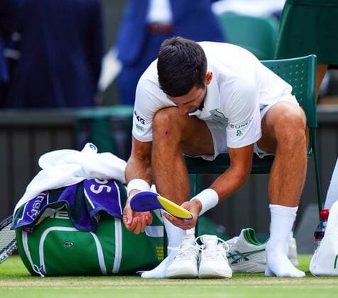 Mandatory Credit: Photo by Javier Garcia Shutterstock (12204578dh) Novak Djokovic changes his tennis shoes during the Gentlemen s Singles final Wimbledon Tennis Championships, Day 13, The All England Lawn Tennis and Croquet Club, London, UK - 11 Jul 2021 Wimbledon Tennis Championships, Day 13, The All England Lawn Tennis and Croquet Club, London, UK - 11 Jul 2021  Copyright: xJavierxGarcia Shutterstockx 12204578dh