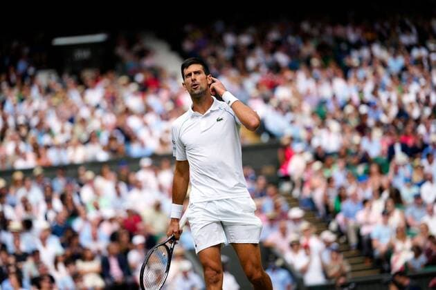Mandatory Credit: Photo by Shutterstock (12204579bu) Novak Djokovic pointing to his ear during the Gentlemen s Singles final Wimbledon Tennis Championships, Day 13, The All England Lawn Tennis and Croquet Club, London, UK - 11 Jul 2021 Wimbledon Tennis Championships, Day 13, The All England Lawn Tennis and Croquet Club, London, UK - 11 Jul 2021  Copyright: xShutterstockx 12204579bu