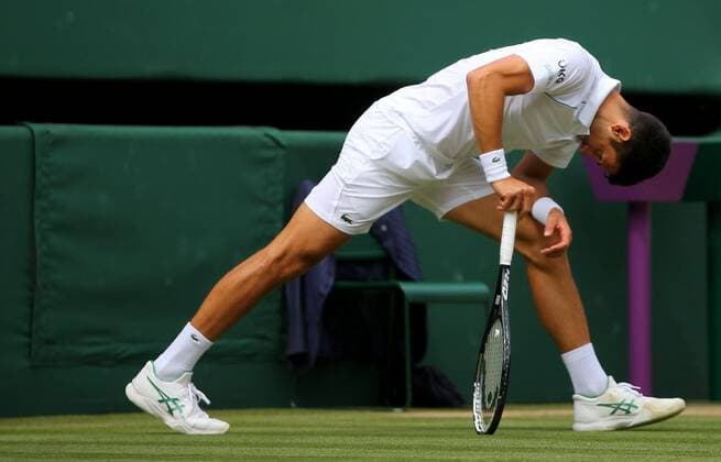 Mandatory Credit: Photo by Shutterstock (12204580k) Novak Djokovic of Serbia stretches his leg Wimbledon Tennis Championships, Day 13, The All England Lawn Tennis and Croquet Club, London, UK - 11 Jul 2021 Wimbledon Tennis Championships, Day 13, The All England Lawn Tennis and Croquet Club, London, UK - 11 Jul 2021  Copyright: xShutterstockx 12204580k