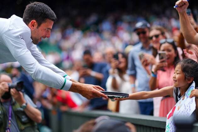 Mandatory Credit: Photo by Javier Garcia Shutterstock (12204578fw) Novak Djokovic hands his racquet to a young fan after victory in the Gentlemen s Singles final Wimbledon Tennis Championships, Day 13, The All England Lawn Tennis and Croquet Club, London, UK - 11 Jul 2021 Wimbledon Tennis Championships, Day 13, The All England Lawn Tennis and Croquet Club, London, UK - 11 Jul 2021  Copyright: xJavierxGarcia Shutterstockx 12204578fw