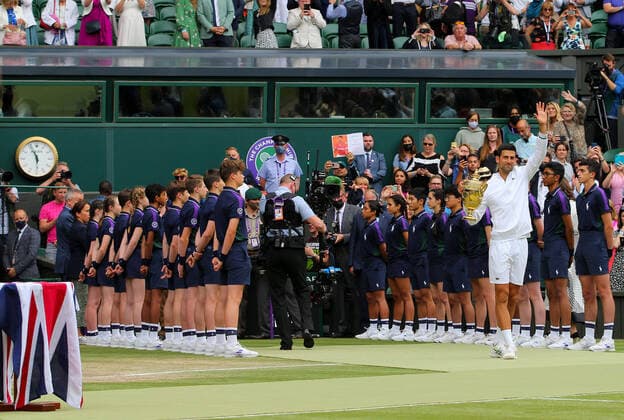Mandatory Credit: Photo by Shutterstock (12204580as) Novak Djokovic of Serbia celebrates with the trophy as he leaves court through the ball boys Wimbledon Tennis Championships, Day 13, The All England Lawn Tennis and Croquet Club, London, UK - 11 Jul 2021 Wimbledon Tennis Championships, Day 13, The All England Lawn Tennis and Croquet Club, London, UK - 11 Jul 2021  Copyright: xShutterstockx 12204580as