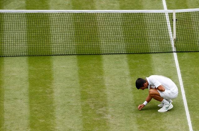 Mandatory Credit: Photo by Shutterstock (12204580ag) Novak Djokovic of Serbia picks a bit of grass to eat Wimbledon Tennis Championships, Day 13, The All England Lawn Tennis and Croquet Club, London, UK - 11 Jul 2021 Wimbledon Tennis Championships, Day 13, The All England Lawn Tennis and Croquet Club, London, UK - 11 Jul 2021  Copyright: xShutterstockx 12204580ag