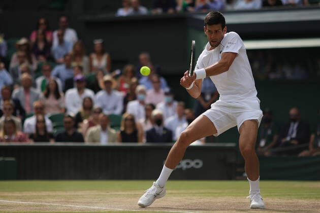 (210712) -- LONDON, July 12, 2021 -- Novak Djokovic of Serbia hits a return during the men s final match between Novak Djokovic of Serbia and Matteo Berrettini of Italy at Wimbledon tennis Championship in London, Britain, on July 11, 2021. (Photo by Xinhua) (SP)BRITAIN-LONDON-TENNIS-WIMBLEDON-MEN S FINAL TimxIreland 