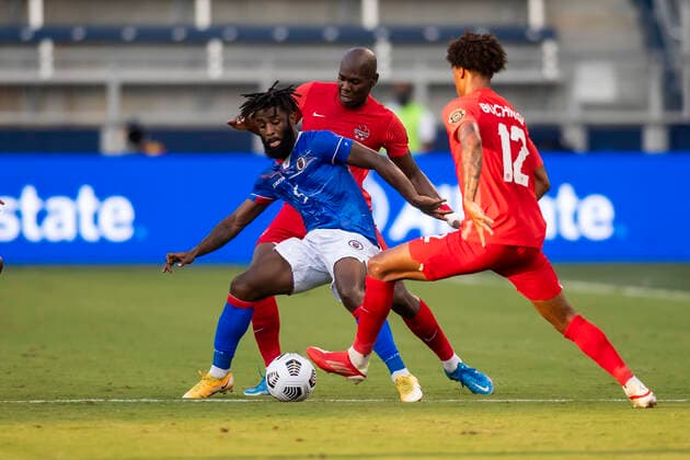 KANSAS CITY, KS - JULY 15: Haiti defender Stephane Lambese (5) attempts to maneuver past the Cananda defense during the CONCACAF Gold Cup match between Canada and Haiti on Thursday July 15, 2021 at ChildrenÕs Mercy Park in Kansas City, KS. (Photo by Nick Tre. Smith Icon Sportswire) SOCCER: JUL 15 Concacaf Gold Cup - Haiti v Canada Icon21071599