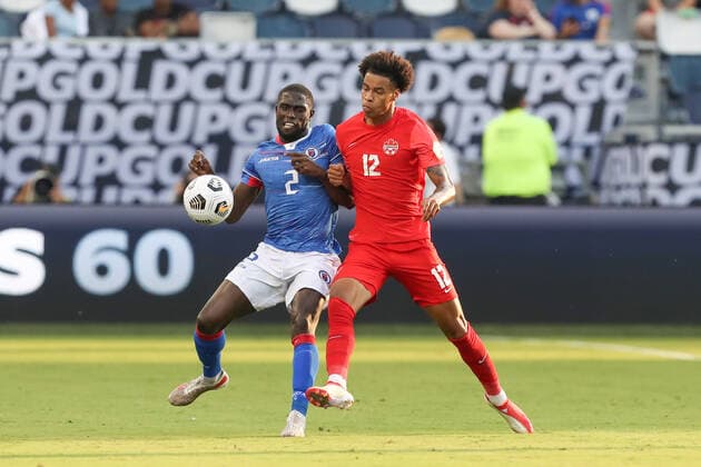 KANSAS CITY, KS - JULY 15: Haiti defender Carlens Arcus (2) and Canada forward Tajon Buchanan (12) collide going for the ball in the second half of a Concacaf Gold Cup match between Haiti and Canada on Jul 15, 2021 at Children s Mercy Park in Kansas City, KS. (Photo by Scott Winters Icon Sportswire) SOCCER: JUL 15 Concacaf Gold Cup - Haiti v Canada Icon2107150161