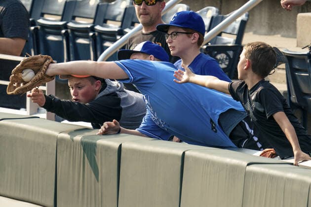 Fans attempt to catch a ball during Baltimore Orioles batting practice before the game against the Kansas City Royals at Kaufman Stadium in Kansas City, Missouri on Friday, July 16, 2021.  KCP20210716104 KYLExRIVAS