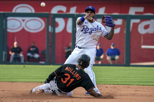 Kansas City Royals second baseman Hanser Alberto (49) attempts to turn the double play after tagging out Baltimore Orioles center fielder Cedric Mullins (31) in the first inning at Kaufman Stadium in Kansas City, Missouri on Friday, July 16, 2021.  KCP20210716109 KYLExRIVAS