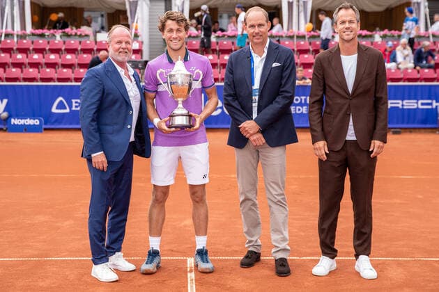 210718 Competition director Christer Hult, Casper Ruud, Norway, Martin A Persson, Nordea, and sports director Magnus Norman after the final in singles during day 14 of the Nordea Open on 18 July 2021 in Bastad,  Copyright: MATHILDAxAHLBERG BB210718BB566