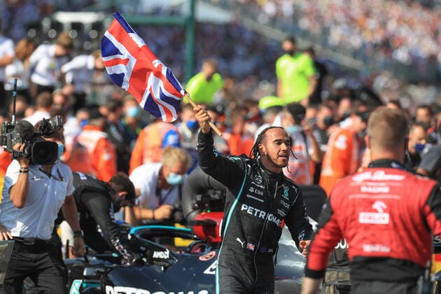 FORMULA 1 BRITISH GRAND PRIX, 18 07 2021 Silverstone Circuit,18 July 2021 Lewis Hamilton (GBR), Mercedes AMG Petronas W12 celebrates winning with Union Jack flag fans during the FORMULA 1 PIRELLI BRITISH GRAND PRIX RACE at Silverstone, United Kingdom Editorial Use Only Copyright: xPhilxDuncanx ESM-0061-0010