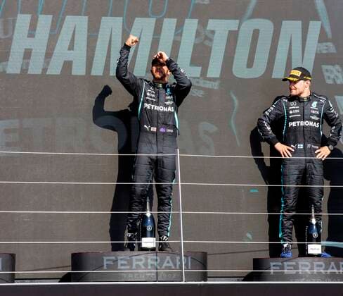 18th July 2021; Silverstone Circuit, Silverstone, Northamptonshire, England; Formula One British Grand Prix, Race Day; Race winner Mercedes AMG Petronas F1 Team driver Lewis Hamilton celebrates his win on the podium next to 3rd placed Bottas  ActionPlus12307238 TimxWilliams