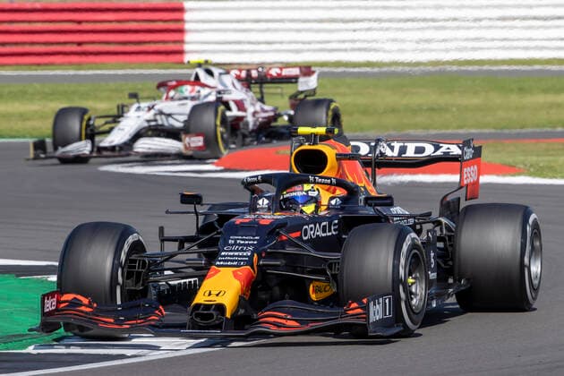 18th July 2021; Silverstone Circuit, Silverstone, Northamptonshire, England; Formula One British Grand Prix, Race Day; Red Bull Racing Honda driver Sergio Perez in his Red Bull Racing RB16B Honda RA621H ahead of Alfa Romeo Racing Orlen driver Antonio Giovinazzi in his Alfa Romeo C41 Ferrari 065 6  ActionPlus12307298 TimxWilliams