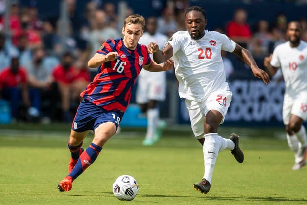 KANSAS CITY, KS - JULY 18: United States defender James Sands (16) and Canada midfielder Harrison Paton (20) chase down the ball during the group B final match between the United States and Canada on Sunday July 18, 2021 at Children™s Mercy Park in Kansas City, KS. (Photo by Nick Tre. Smith Icon Sportswire) SOCCER: JUL 18 Concacaf Gold Cup - USA v Canada Icon2107180037