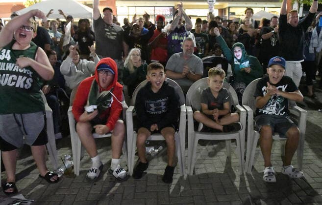 July 20, 2021, Racine, Wisconsin, USA: Young fans cheer as a crowd estimated at up to 1,000 people watches the final minutes of the Milwaukee Bucks 105-98 victory over the Phoenix Suns to win the NBA, Basketball Herren, USA Championship at the â€oeDeer District Downtown†in Racine, Wisconsin Tuesday July 20, 2021. It was their first championship in 50 years. The â€oeDeer District Downtown,†modeled after the Deer District outside the Bucks arena in Milwaukee, enabled fans to gather on Monument Square in the middle of downtown and watch the game on large screen TVs. Racine USA - ZUMAh154 20210720_znp_h154_003 Copyright: xMarkxHertzbergx