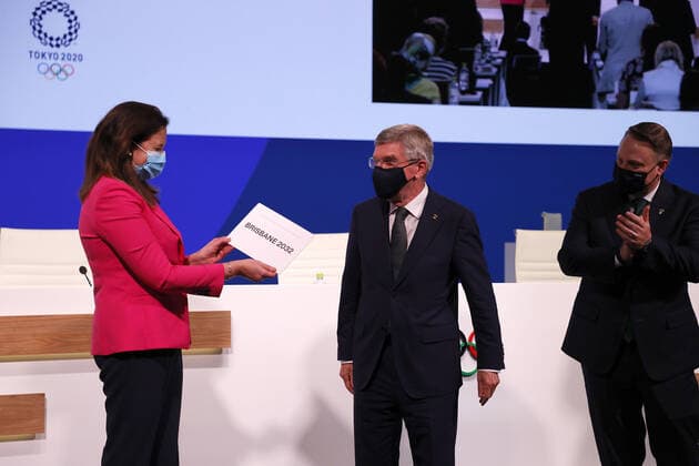 (210721) -- TOKYO, July 21, 2021 -- President of the International Olympic Committee Thomas Bach (C) presents the Honourable Annastacia Palaszczuk MP (L), Premier of Queensland and Minister for Trade, with a card after Brisbane was announced as the 2032 Summer Olympics host city during the 138th International Olympic Committee (IOC) Session in Tokyo, Japan, on July 21, 2021. ( Pool via Xinhua) (SP)TOKYO-JAPAN-IOC-138TH SESSION ToruxHanai 
