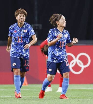Tokyo Olympics: Football Mana Iwabuchi (R) reacts after scoring the equalizer in Japan s 1-1 draw with Canada during the second half of their Group E match of the Tokyo Olympic women s football tournament on July 21, 2021, at Sapporo Dome in northern Japan.  A14AA0000753387P