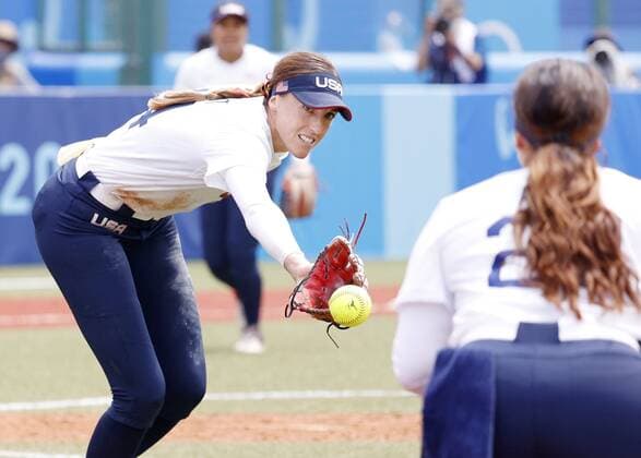 Tokyo Olympics: Softball U.S. pitcher Monica Abbott (L) tosses the ball with her glove in the fifth inning against Canada in the opening round of the Tokyo Olympic softball tournament at Fukushima Azuma stadium in Fukushima, northeastern Japan, on July 22, 2021.  A14AA0000753444P