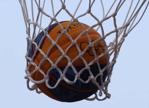 TOKYO, JAPAN - JULY 24, 2021: A ball is pictured in the net during the women s 3x3 basketball pool round match between ROC Team and Japan at the 2020 Summer Olympic Games, Olympische Spiele, Olympia, OS at Aomi Urban Sports Park. Stanislav Krasilnikov TASS  TS1091BE