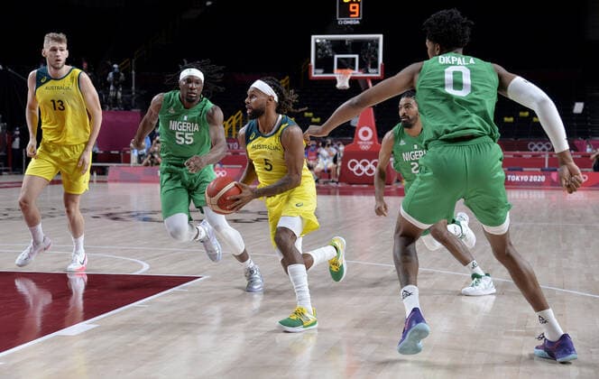 Australia s Patty Mills (C) dribbles through Nigeria s defenders Precious Achiuwa (55), Nnamdi Vincent (22) and Chikezie Okpala (0) as teammate Jock Landale (L) watches during Men s Basketball game at the Tokyo 2020 Olympics, Sunday, July 25, 2021, in Tokyo, Japan.  OLY20210725811 MIKExTHEILER