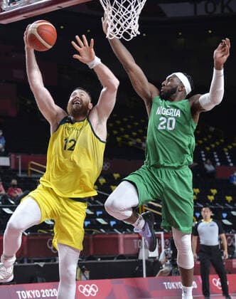 Australia s Aron Baynes (L) drives to the basket against Nigeria s Josh Okogie during Men s Basketball game at the Tokyo 2020 Olympics, Sunday, July 25, 2021, in Tokyo, Japan.  OLY20210725820 MIKExTHEILER