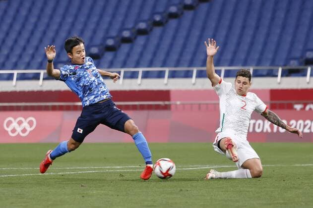 Tokyo Olympics: Football Japan s Takefusa Kubo (L) opens the scoring against Mexico during the first half of their Group A men s football match of the Tokyo Olympics on July 25, 2021, at Saitama Stadium in Saitama, eastern Japan. (SELECTION)  A14AA0000754342P