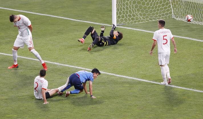 Tokyo Olympics: Football Japan s Takefusa Kubo (blue) opens the scoring against Mexico during the first half of their Group A men s football match of the Tokyo Olympics on July 25, 2021, at Saitama Stadium in Saitama, eastern Japan.  A14AA0000754344P