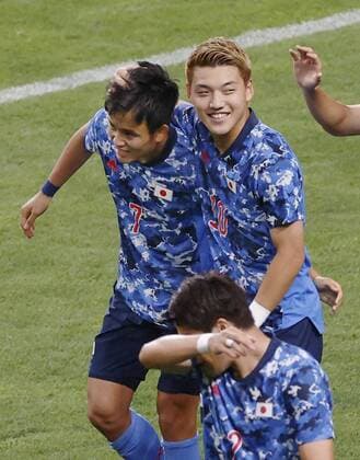 Tokyo Olympics: Football Ritsu Doan (R) of Japan congratulates Takefusa Kubo for his opening goal against Mexico during the first half of their Group A men s football match of the Tokyo Olympics on July 25, 2021, at Saitama Stadium in Saitama, eastern Japan.  A14AA0000754346P