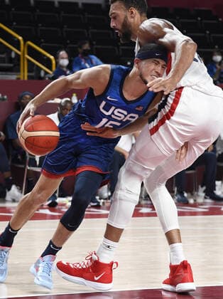 The United States Devin Booker (L) attempts to drive past France s Rudy Gobert during a Men s Basketball game at the Tokyo 2020 Olympics, Sunday, July 25, 2021, in Tokyo, Japan.  OLY20210725899 MIKExTHEILER
