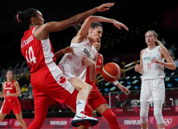July 26, 2021, Tokyo, Japan: Team Serbia centre Dragana Stankovic (14) tries to drive past Team Canada centre Kayla Alexander (14) and forward Miranda Ayim (9) during first half Olympic basketball action at the Tokyo Olympics in Tokyo, Japan on Monday, July 26, 2021. Canada News - July 26, 2021  - ZUMAc35_ 20210726_zaf_c35_022 Copyright: xNathanxDenettex