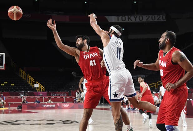 United States Javale McGee (C) and Iran s Arsalan Kazemi battle for a rebound as Iran s Hamed Haddadi (R) looks on during a Men s Basketball game at the Tokyo 2020 Olympics, Wednesday, July 28, 2021, in Tokyo, Japan. The USA won easily, 120-66.  OLY20210728807 MIKExTHEILER