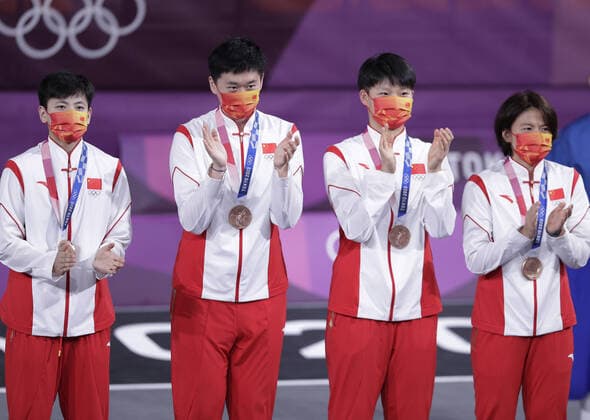 China s Zhiting Zhang, Jiyuan Wan, Lili Wang and Shuyu Yang (L to R) stand on the podium after defeating France to win the bronze medal in Women s 3X3 Basketball at the Tokyo Summer Olympics in Tokyo, Japan, on Wednesday, July 28, 2021. This was the first year 3X3 basketball was an Olympic event.  OLY20210728630 BOBxSTRONG