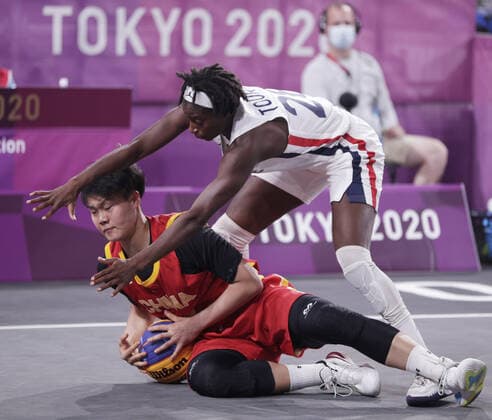 Mamignan Toure of France (28) fights for the ball with China s Zhiting Zhang (10) during the Women s 3X3 Basketball bronze medal game at the Tokyo Summer Olympics in Tokyo, Japan, on Wednesday, July 28, 2021. China won the game to take the bronze medal.  OLY20210728644 BOBxSTRONG