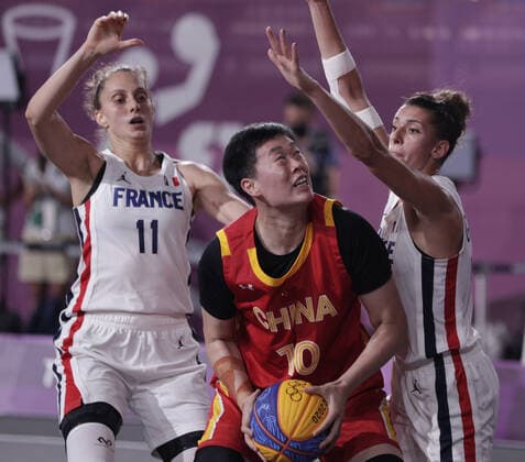 China s Zhiting Zhang (10) is guarded by Ana Maria Filip of France (11) and Laetitia Guapo during the Women s 3X3 Basketball bronze medal game at the Tokyo Summer Olympics in Tokyo, Japan, on Wednesday, July 28, 2021. China won the game to take the bronze medal.  OLY20210728645 BOBxSTRONG