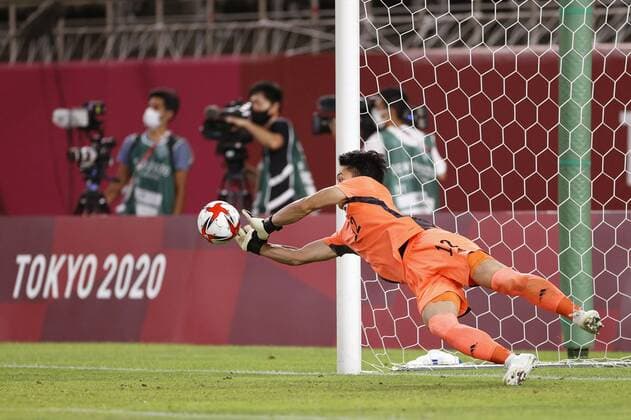 Tokyo Olympics: Football Japan goalkeeper Kosei Tani stops a shot by New Zealand s Liberato Cacace in a penalty shootout in their men s football quarterfinal of the Tokyo Olympics on July 31, 2021, at Kashima Stadium in Ibaraki Prefecture, eastern Japan.  A14AA0000755556P