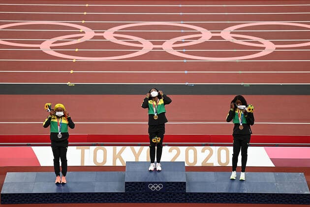 (210801) -- TOKYO, Aug. 1, 2021 -- Gold medalist Elaine Thompson-Herah (C), silver medalist Shelly-Ann Fraser-Pryce (L) and bronze medalist Shericka Jackson of Jamaica react during the awarding ceremony of the Women s 100m at the Tokyo 2020 Olympic Games, Olympische Spiele, Olympia, OS in Tokyo, Japan, Aug. 1, 2021. ) (TOKYO2020)JAPAN-TOKYO-OLY-ATHLETICS-WOMEN S 100M-AWARDING CEREMONY LixYibo 