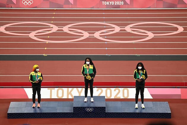 (210801) -- TOKYO, Aug. 1, 2021 -- Gold medalist Elaine Thompson-Herah (C), silver medalist Shelly-Ann Fraser-Pryce (L) and bronze medalist Shericka Jackson of Jamaica react during the awarding ceremony of the Women s 100m at the Tokyo 2020 Olympic Games, Olympische Spiele, Olympia, OS in Tokyo, Japan, Aug. 1, 2021. ) (TOKYO2020)JAPAN-TOKYO-OLY-ATHLETICS-WOMEN S 100M-AWARDING CEREMONY LixYibo 
