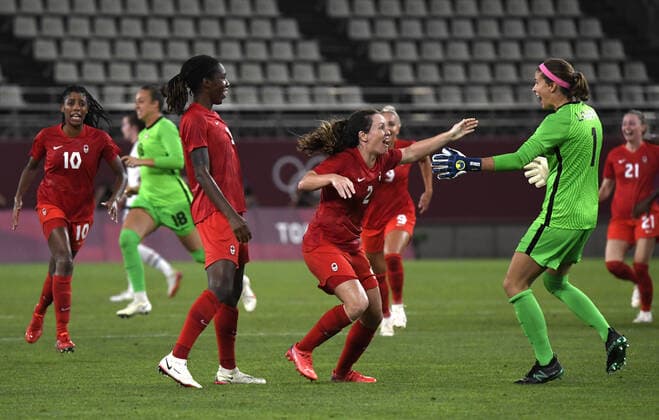 (L-R) Canada s Ashley Lawrence, Kadeisha Buchanan, Alysha Chapman and Stephanie Labbe share in the jubilation at the conclusion of their win against the United States during the Women s Soccer semi-final match at the Tokyo 2020 Olympics, Monday, August 2, 2021, in Kashima, Japan. Canada defeated the USA 1-0 on a penalty kick.  OLY20210802805 MIKExTHEILER