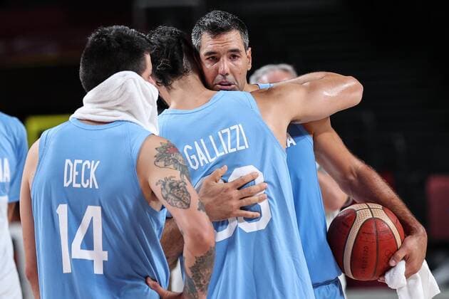 (210803) -- SAITAMA, Aug. 3, 2021 -- Luis Scola (R) of Argentina hugs his teammate after the men s basketball quarterfinal match between Australia and Argentina at Tokyo 2020 Olympic Games, Olympische Spiele, Olympia, OS in Saitama, Japan, Aug. 3, 2021. ) (TOKYO2020)JAPAN-SAITAMA-OLY-BASKETBALL-MEN S QUARTERFINAL-AUS VS ARG PanxYulong 
