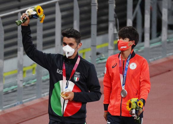 Gold and silver medalists Massimo Stano of Italy and Koki Ikeda of Japan celebrate with their medals after competiting in the Men s 20km Race Walk at the Tokyo 2020 Summer Olympic Games, Olympische Spiele, Olympia, OS in Tokyo, Japan on Friday, August 6, 2021.  OLY20210806302 BobxStrong