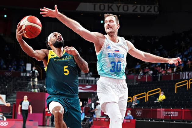 Australia point guard Patty Mills (5) slips past Slovenia guard Zoran Dragic (30), as he drives to the basket during the Men s Basketball bronze medal game at the Tokyo Olympic Games, Olympische Spiele, Olympia, OS in Tokyo, Japan, on Saturday, August 7, 2021.  OLY20210807253 RICHARDxELLIS