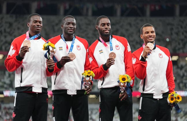 (210807) -- TOKYO, Aug. 7, 2021 -- Team members of Canada react during the awarding ceremony of the Men s 4x100m Relay at the Tokyo 2020 Olympic Games, Olympische Spiele, Olympia, OS in Tokyo, Japan, Aug. 7, 2021. ) (TOKYO2020)JAPAN-TOKYO-OLY-ATHLETICS-MEN S 4x100M RELAY-AWARDING CEREMONY LuixSiuxWai 