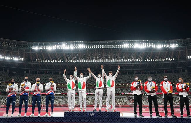 (210807) -- TOKYO, Aug. 7, 2021 -- Team members of Italy (C), the Great Britain (L) and Canada react during the awarding ceremony of the Men s 4x100m Relay at the Tokyo 2020 Olympic Games, Olympische Spiele, Olympia, OS in Tokyo, Japan, Aug. 7, 2021. ) (TOKYO2020)JAPAN-TOKYO-OLY-ATHLETICS-MEN S 4x100M RELAY-AWARDING CEREMONY LuixSiuxWai 