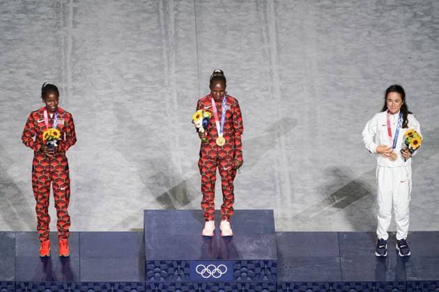Tokyo, Japan, August 8th 2021: Gold medalist Peres Jepchirchir (Kenya, middle), silver medalist Brigid Kosgei (Kenya, left) and bronze medalist Molly Seidel (USA) during their medal ceremony during the Tokyo Olympics 2020 closing ceremony at the Olympic Stadium in Tokyo, Japan. Closing ceremony - Tokyo Olympics 2020 