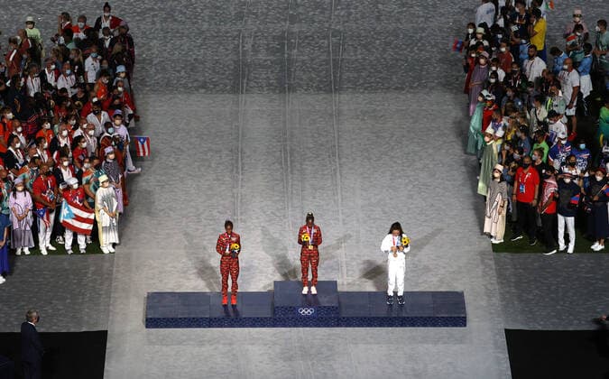 TOKYO, JAPAN - AUGUST 8, 2021: Silver medallist Brigid Kosgei of Kenya, gold medal winner Peres Jepchirchir of Kenya and bronze medallist Molly Seidel of the United States (L-R centre) attend the victory ceremony for the ladies marathon final during the closing ceremony of the 2020 Summer Olympic Games, Olympische Spiele, Olympia, OS at the Japan National Stadium (a.k.a the Olympic Stadium). The Olympic Games were held amid the COVID-19 pandemic. The closing ceremony features live and pre-recorded elements. Sergei Bobylev TASS  TS10C10C