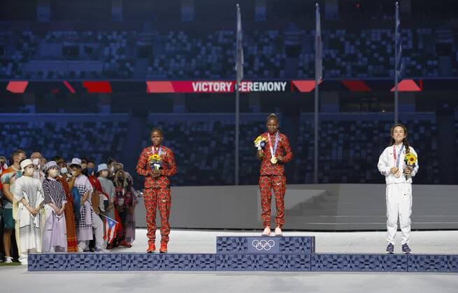 Tokyo Olympics: Athletics Tokyo Olympic women s marathon gold medalist Peres Jepchirchir (C) of Kenya stands on the podium at the victory ceremony held during the closing ceremony of the games at the National Stadium in Tokyo on Aug. 8, 2021, alongside compatriot Brigid Kosgei (L) and Molly Seidel of the United States, who took silver and bronze, respectively.  A14AA0000757505P