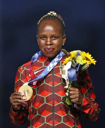 Tokyo Olympics: Athletics Peres Jepchirchir of Kenya poses with her Tokyo Olympic marathon gold medal at the victory ceremony held during the closing ceremony of the games at the National Stadium in Tokyo on Aug. 8, 2021.  A14AA0000757513P
