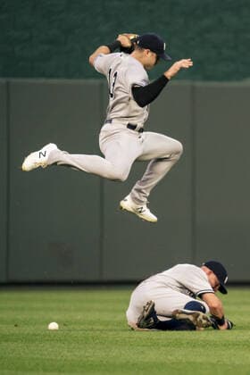 New York Yankees center fielder Joey Gallo (13) leaps over left fielder Brett Gardner (11) after Gardner failed to catch the Kansas City Royals fly ball in the third inning at Kaufman Stadium in Kansas City, Missouri on Monday, August 09, 2021.  KCP20210809115 KYLExRIVAS