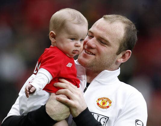Mandatory Credit: Photo by Back Page Images Shutterstock (1178998d) Wayne Rooney of Manchester United, ManU with baby Kai at the end of the game Manchester United v Stoke City, FA Premier League football match, Old Trafford, Britain - 09 May 2010 Manchester United beat Stoke 4-0 EDITORIAL USE ONLY No use with unauthorised audio, video, data, fixture lists (outside the EU), club league logos or live services. Online in-match use limited to 45 images (+15 in extra time). No use to emulate moving images. No use in betting, games or single club league player publications services. Manchester United v Stoke City, FA Premier League football match, Old Trafford, Britain - 09 May 2010 EDITORIAL USE ONLY No use with unauthorised audio, video, data, fixture lists (outside the EU), club league logos or live services. Online in-match use limited to 45 images (+15 in extra time). No use to emulate moving images. No use in betting, games or Copyright: xBackxPagexImages Shutterstockx 1178998d