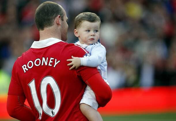 Mandatory Credit: Photo by Back Page Images Shutterstock (1327140n) Wayne Rooney of Manchester United, ManU with his son Kai at the end of the game Manchester United v Blackpool, FA Premier League football match, Old Trafford, Manchester, Britain - 22 May 2011 EDITORIAL USE ONLY No use with unauthorised audio, video, data, fixture lists (outside the EU), club league logos or live services. Online in-match use limited to 45 images (+15 in extra time). No use to emulate moving images. No use in betting, games or single club league player publications services. Manchester United v Blackpool, FA Premier League football match, Old Trafford, Manchester, Britain - 22 May 2011 EDITORIAL USE ONLY No use with unauthorised audio, video, data, fixture lists (outside the EU), club league logos or live services. Online in-match use limited to 45 images (+15 in extra time). No use to emulate moving images. No use in betting, games or Copyright: xBackxPagexImages Shutterstockx 1327140n